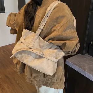 Minimalist beige suede tote bag with decorative metal buckle straps and thick texture