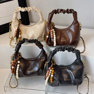 Hobo shoulder bag with pleated handle and bohemian bead charm in multiple colors