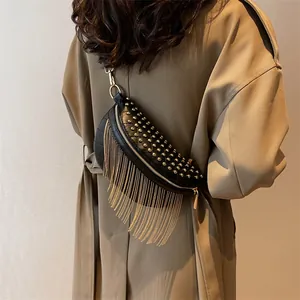 Fashionable black PU leather crescent crossbody bag with gold studs and long fringe tassels