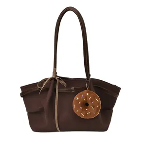 Brown large capacity tote bag with long handles and a cute donut plush charm