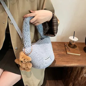 Plush light blue lamb wool tote bag with teddy bear charm and brown strap detail
