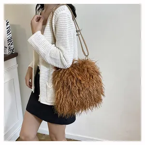 Brown fluffy faux fur crossbody bag shown on model with adjustable slim strap