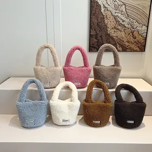 Fleece bucket handbags in seven colors displayed on white stairs for a modern look