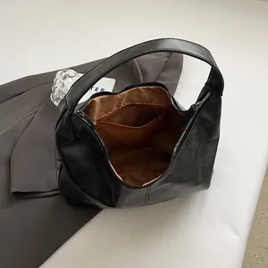 Classic black leather hobo shoulder bag with zipper closure and large capacity for commuting