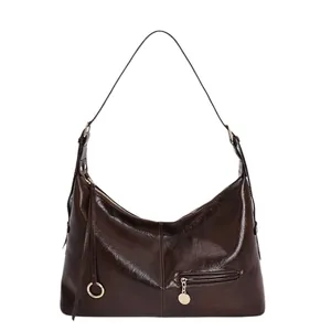 Vintage dark brown shoulder bag in glossy leather finish with front zip pocket detail