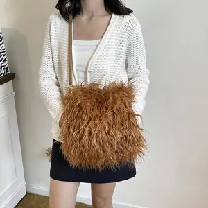 Brown faux fur plush crossbody bag with slim adjustable strap on a female model