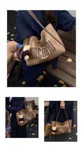 Detail view of the brown retro tote bag with MICAORI logo and a cute bear keychain