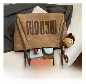 Brown faux leather tote bag interior showing capacity for tablet and daily items