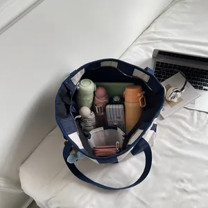 Large capacity navy checkered canvas tote bag showing interior storage for daily essentials