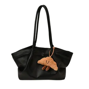 Classic black leather tote bag with lychee texture and creative plush croissant pendant