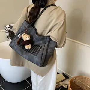 Maillard style dark grey faux leather tote bag with embossed letters and plush bear charm