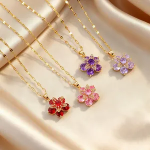 Close-up of four floral gemstone necklaces with colorful zircons on champagne silk
