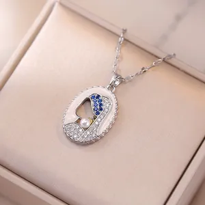 Enamel pendant necklace featuring Girl with a Pearl Earring design and blue gemstone inlay