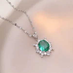 Elegant emerald green oval flower pendant necklace on beige silk background