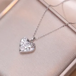 Macro shot of silver heart pendant featuring multi-shape crystal inlay on a silk box