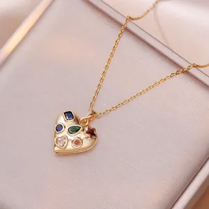 Chic heart pendant necklace in gold finish featuring six colorful inlaid crystals