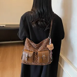 Retro leopard print crossbody bag with brown leather pockets and plush bear charm