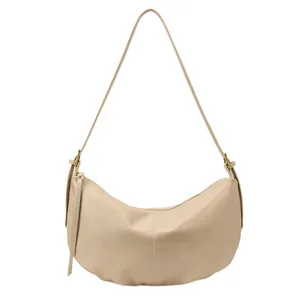 Minimalist beige dumpling hobo bag with pleated texture and adjustable strap in main view