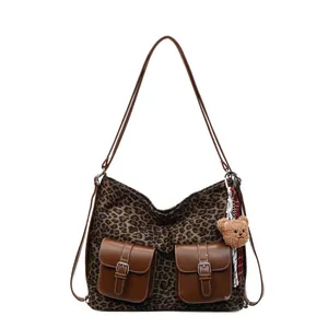 Vintage leopard print crossbody bag with dual pockets and a cute plush bear pendant