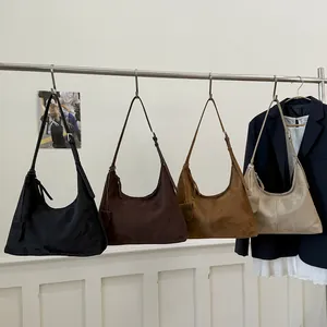 Large hobo tote bags in four colors hanging on a rack for a chic minimalist look