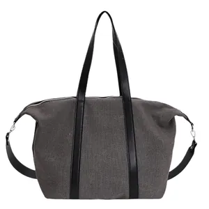 Large capacity canvas tote bag with black leather handles and crossbody strap in dark grey