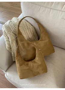 Detailed comparison of large and small retro matte tote bags on a fabric sofa