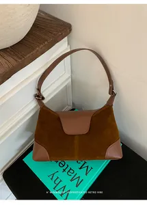 Close-up of vintage brown suede and leather patchwork detail on the commute handbag