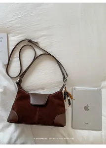 Close-up of retro brown suede patchwork handbag next to an iPad for size reference