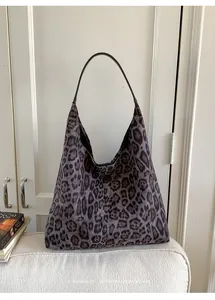 Macro shot of minimalist leopard print hobo bag texture and elegant leather strap detail