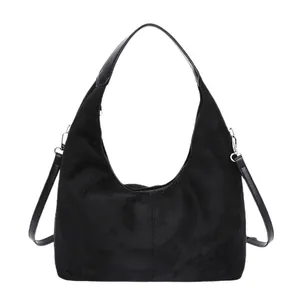 Minimalist black suede hobo bag with a versatile detachable shoulder strap and matte finish