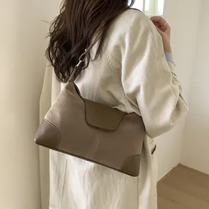 Brown suede and leather patchwork crossbody bag with adjustable strap for commuting