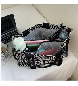 Interior view of zebra print canvas tote bag showing spacious compartments and daily essentials