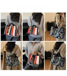 Detailed views of a striped canvas tote bag featuring a GOODTIMES strap and floral charm