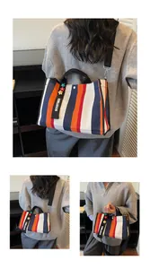 Detail of striped canvas tote bag with Goodtimes pendant and black adjustable shoulder strap