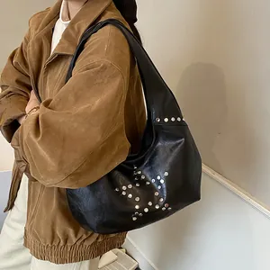 Black leather punk tote bag with silver star rivet patterns and wide shoulder straps