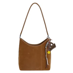 Brown suede hobo shoulder bag with crescent shape and heart-shaped pendant charms