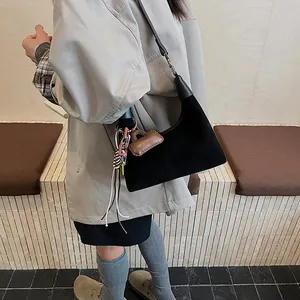 Fashionable black suede bucket bag for women with vintage charms and shoulder strap