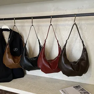 Sacs portés épaule vintage en cuir marron et noir exposés en vitrine