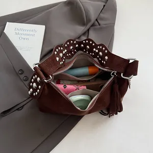 Vintage brown frosted leather tote with stud details and fringe showing large capacity