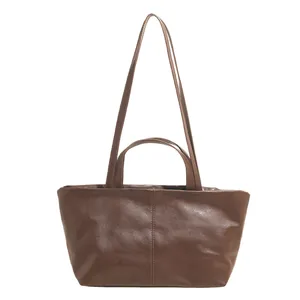 Brown large capacity tote bag with dual handles and elegant vertical stitching detail