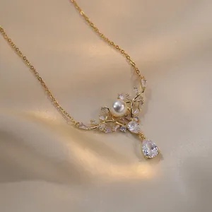 Detailed view of a golden deer pendant necklace with pearl and drop-shaped crystal