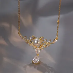 Detailed view of a gold pearl pendant with crystal stones on dark silk background