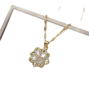 Elegant gold necklace with flower pendant featuring four marquise-cut cubic zirconia stones