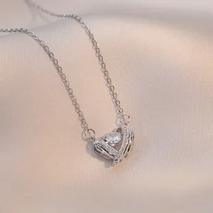 Silver guardian heart wing necklace with sparkling zircon pendant on silk background