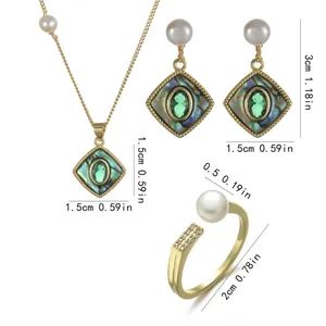 Detailed view of bohemian gold jewelry set with green stones, pearls and abalone shell
