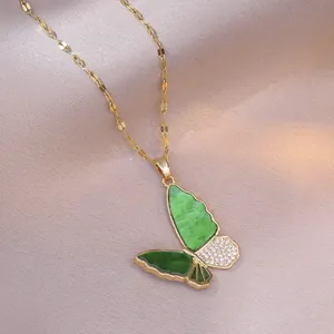 Golden necklace with green gradient butterfly pendant and crystals on purple silk