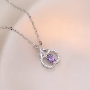 Silver apple pendant necklace with purple zircon and pave crystal stones on pink silk