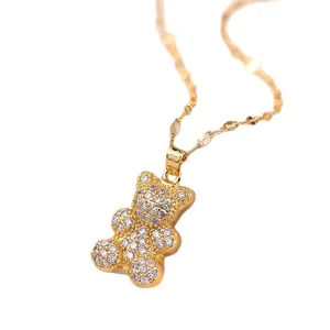 Macro detail of gold bear pendant necklace featuring sparkling pavé cubic zirconia