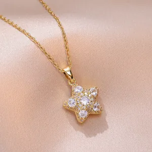 Macro view of gold star pendant necklace with white zircons on champagne silk fabric