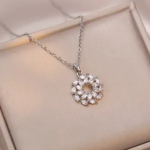 Elegant silver flower wreath pendant necklace with marquise-cut zircons on a champagne box